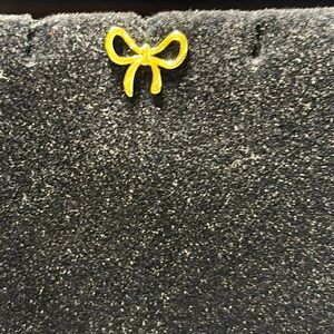 Bow stud earring
New.  
Pet / smoke free home